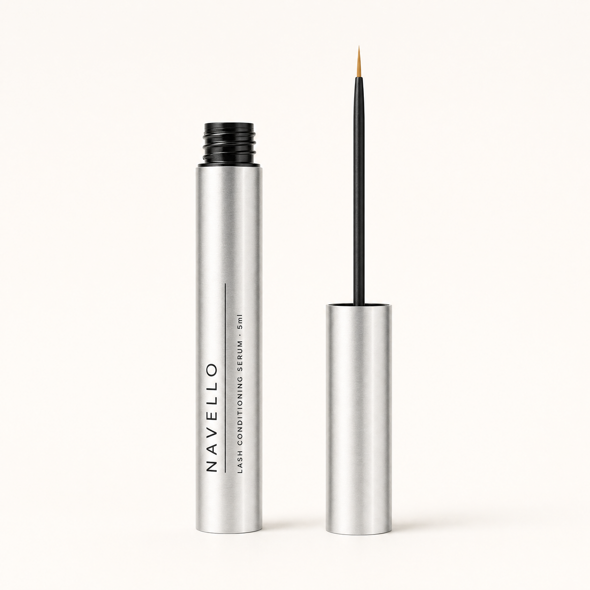 The Navello tube open beside its cap, with a fine applicator wand and a clean dry bristle tip.